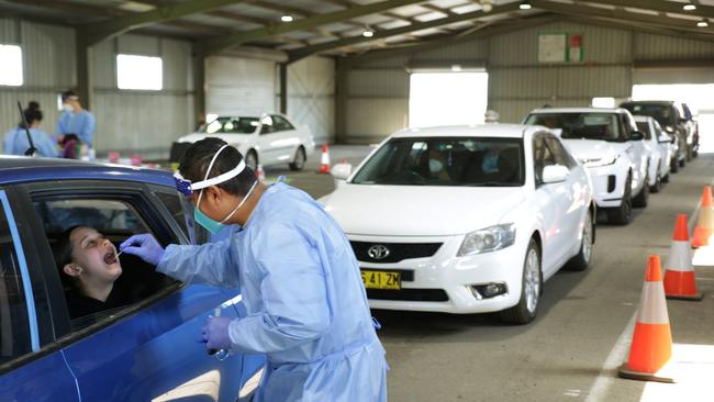 Long queues for drive-through Covid testing at Dubbo showground, as Bella Duke, 12, akes her turn. Picture Dean Marzolla.