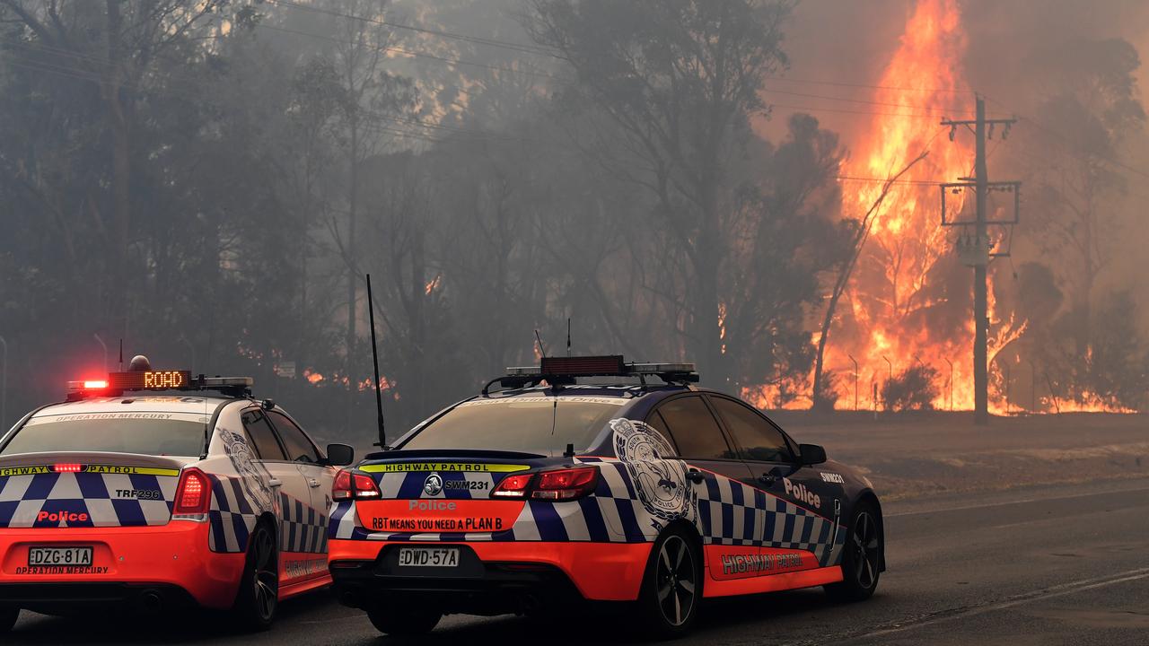 Police block access to parts of the Old Hume Highway near the town of Tahmoor on Thursday as the Green Wattle Creek Fire threatened communities. Picture: AAP