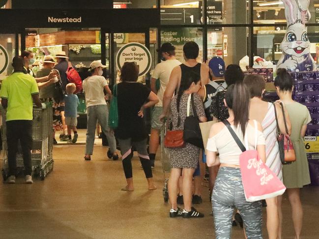 A line-up out the door at Gasworks Woolworths, in Brisbane. Picture: Liam Kidston