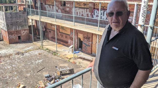 Longtime Hay St resident Kevin Schwab has helped out with ongoing repairs to the trashed former rooming house at Hays International College. Picture: Kiel Egging