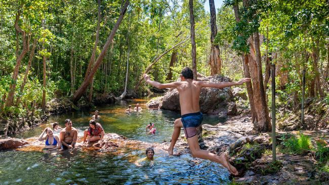 Sharma Ah-Wing jumps into the Buley Rockhole while his family looks on. Picture: Che Chorley