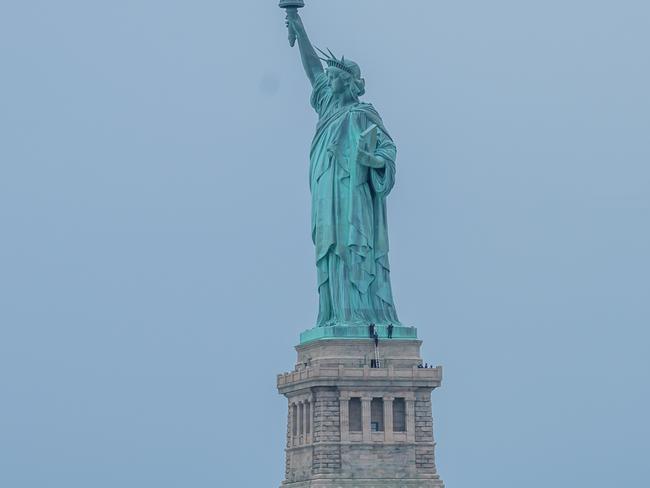 STATUE OF LIBERTY - LIBERTY ISLAND, NEW YORK, UNITED STATES - 2018/07/04: Liberty Island was evacuated because of a person climbing the Statue of Liberty's base on the Fourth of July shortly after seven protesters who unfurled an "Abolish ICE" banner from the statue's pedestal calling for abolishing Immigration and Customs Enforcement were arrested. (Photo by Erik McGregor/Pacific Press/LightRocket via Getty Images)