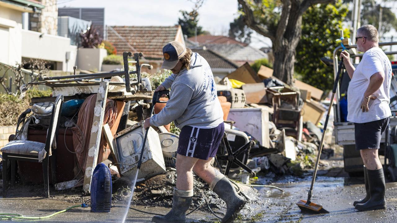 Residents of Clyde St in Maribyrnong begin the clean-up after recent flooding. Picture: NCA NewsWire / Aaron Francis