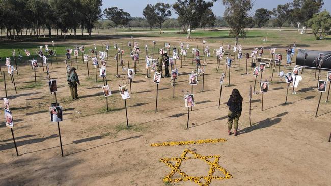 Israeli soldiers walk among the pictures of people taken captive or killed by Hamas militants during the Supernova music festival on October 7. Polling suggests about half of Gazans back Hamas and about three-quarters thought the barbarism of October 7 was justified. Picture: Jack Guez/AFP