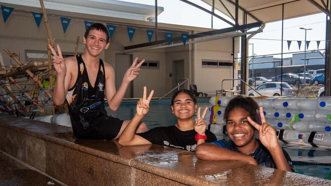 Henbury School students Natalia, Jade, and Dennis prepare their boat for the Beer Can Regatta, 2024. Picture: Pema Tamang Pakhrin