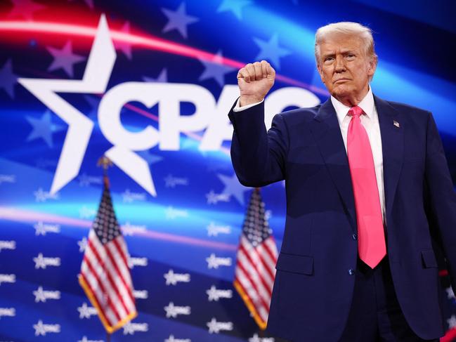 OXON HILL, MARYLAND - FEBRUARY 22: U.S. President Donald Trump reacts to the crowd while arriving at the Conservative Political Action Conference (CPAC) at the Gaylord National Resort Hotel and Convention Center on February 22, 2025 in Oxon Hill, Maryland. The annual four-day gathering brings together conservative U.S. lawmakers, international leaders, media personalities and businessmen to discuss and champion conservative ideas.   Win McNamee/Getty Images/AFP (Photo by WIN MCNAMEE / GETTY IMAGES NORTH AMERICA / Getty Images via AFP)