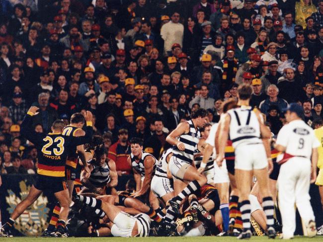 Matthew Liptak lies injured on the ground as a fight develops nearby during a Crows-Geelong match in 1996.