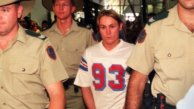 Ben William McLean escorted by heavy police guard arrives at Darwin Airport.