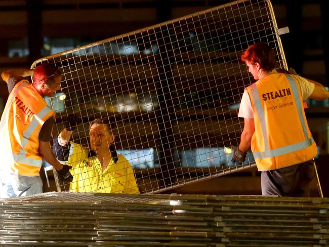 Workers dismantle the security barriers outside the Sofitel Hotel after the G20. Pic Darren England.