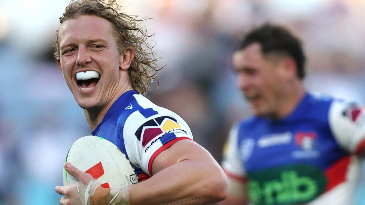 SYDNEY, AUSTRALIA - JULY 02: Phoenix Crossland of the Knights makes a break and scores a try during the round 18 NRL match between Canterbury Bulldogs and Newcastle Knights at Accor Stadium on July 02, 2023 in Sydney, Australia. (Photo by Jeremy Ng/Getty Images)