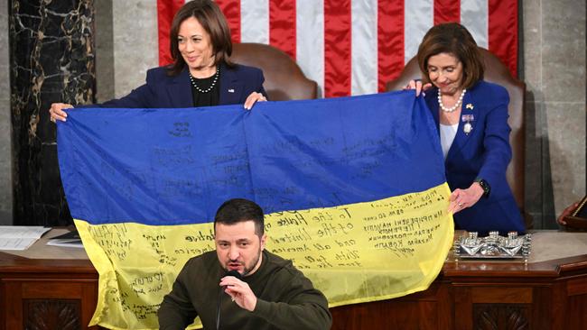 Ukraine's President Volodymyr Zelensky speaks after giving a Ukrainian national flag to US house Speaker Nancy Pelosi and US Vice-President Kamala Harris during his address the US Congress. Picture: AFP