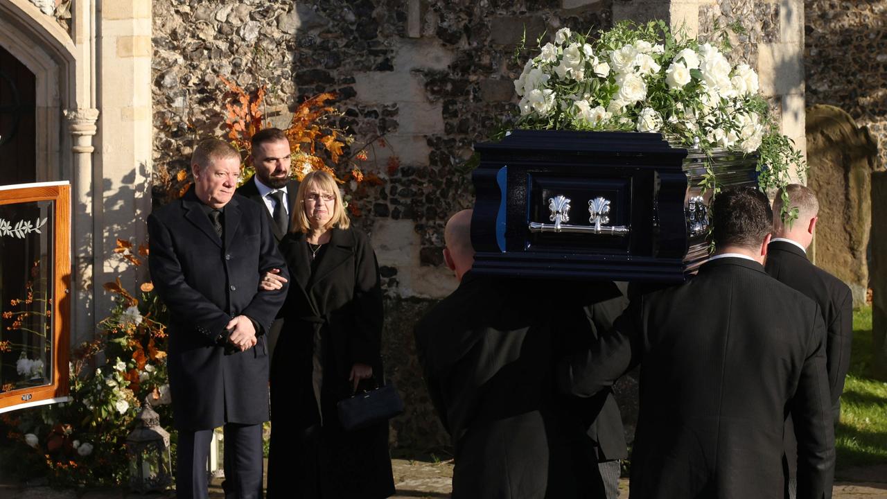 Karen and Geoff Payne watch as his coffin is carried into the funeral. Picture: Dan Kitwood/Getty Images