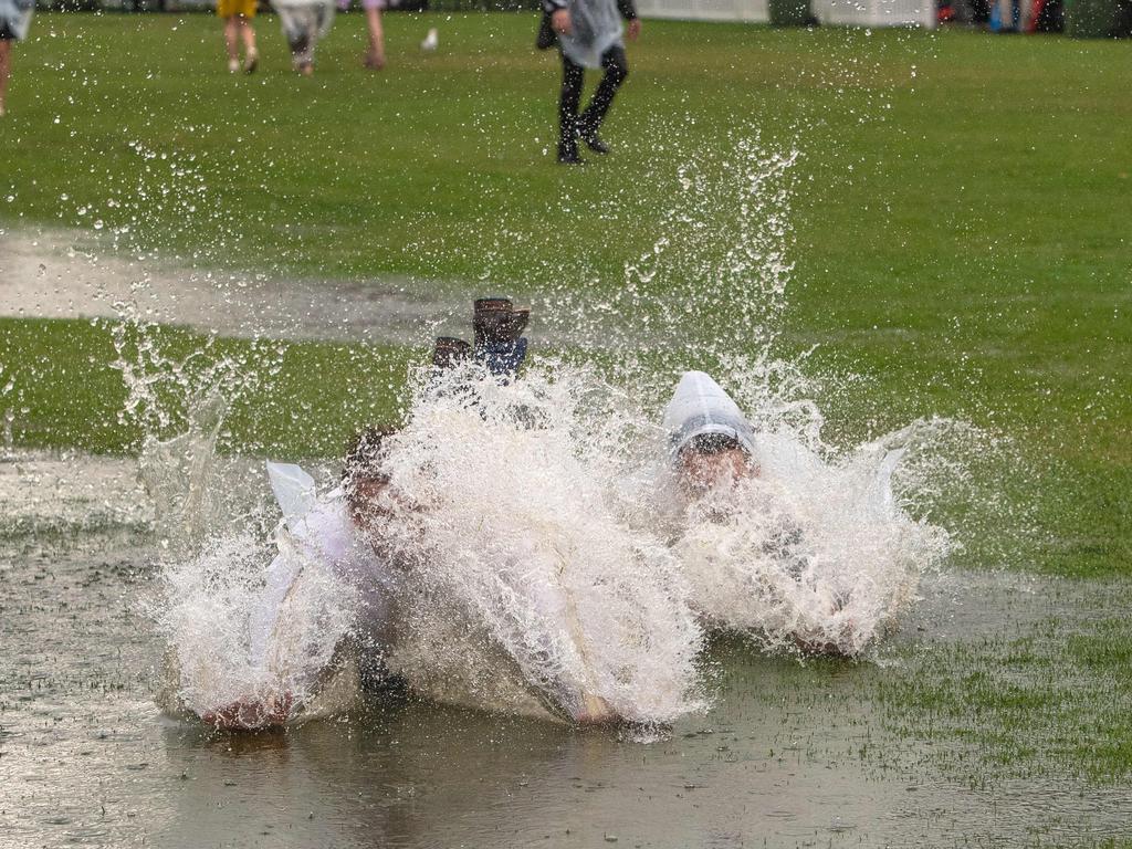 Punters arrive in the rain at Flemington. Picture: Jason Edwards