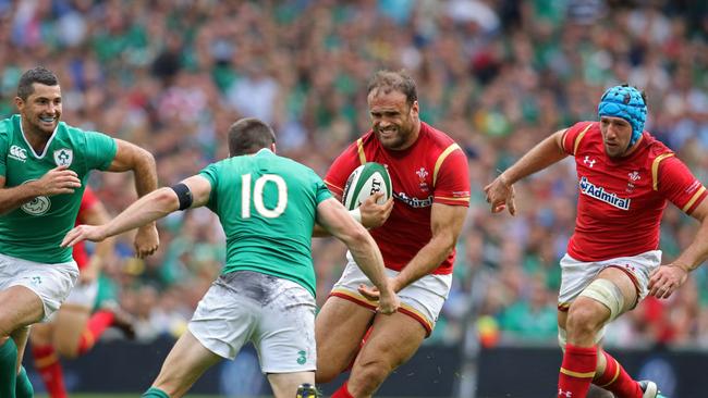 Wales centre Jamie Roberts is tackled by Ireland fly half Johnny Sexton.