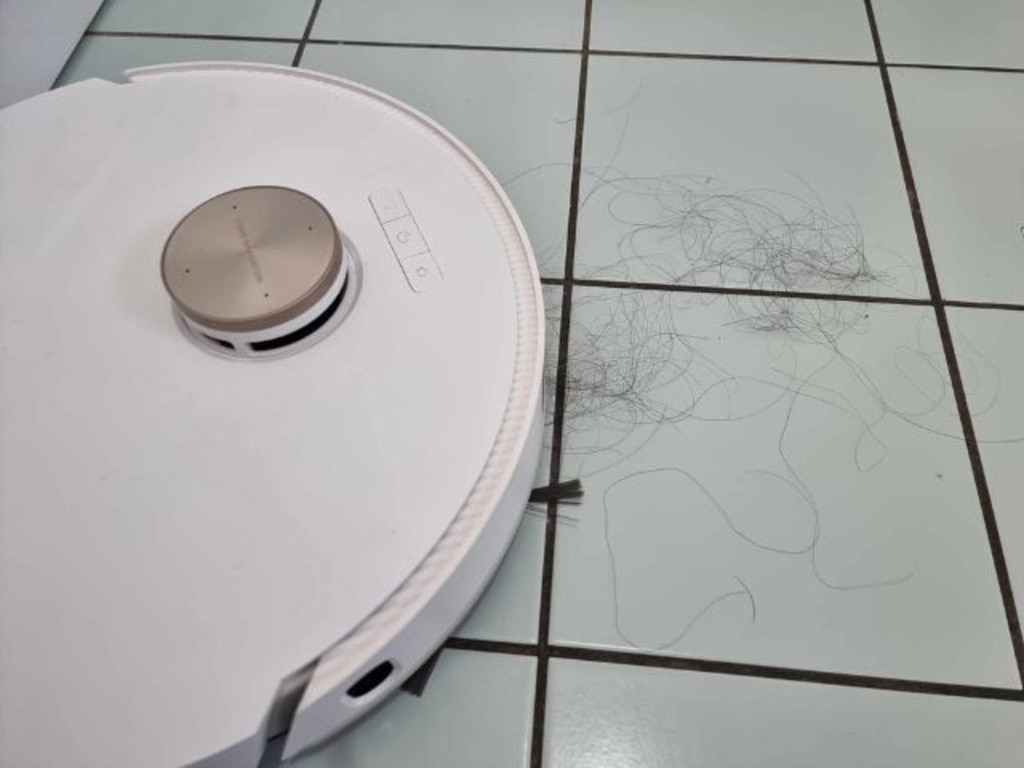 The Dreame L20 Ultra vacuuming hair on bathroom tiles (before). Picture: Tahnee-Jae Lopez-Vito/news.com.au.