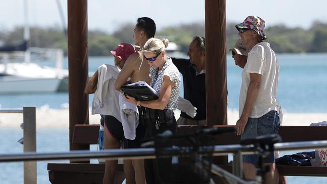 Police were seen speaking with witnesses at the popular swimming spot in Labrador. Picture: Nigel Hallett