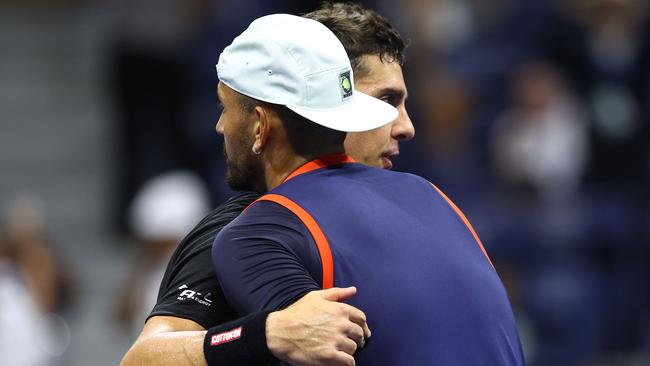 Nick Kyrgios and Thanasi Kokkinakis hug after their Round 1 match.