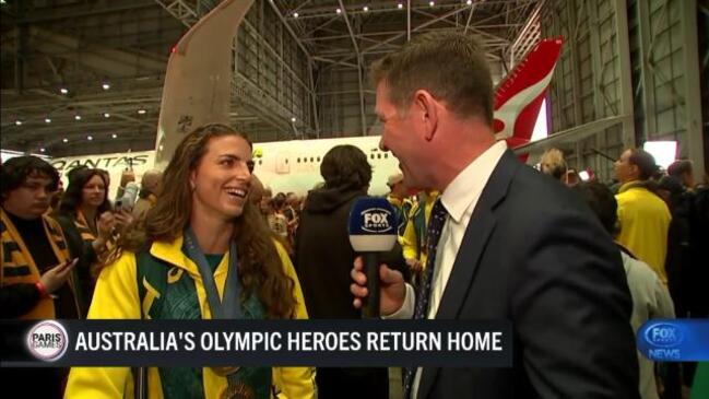 Record breaking Olympic team arrive home