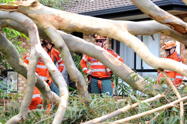 SES hard at work cleaning up the mess in Little Mountain following ferocious storm on Saturday. Picture: John Gass