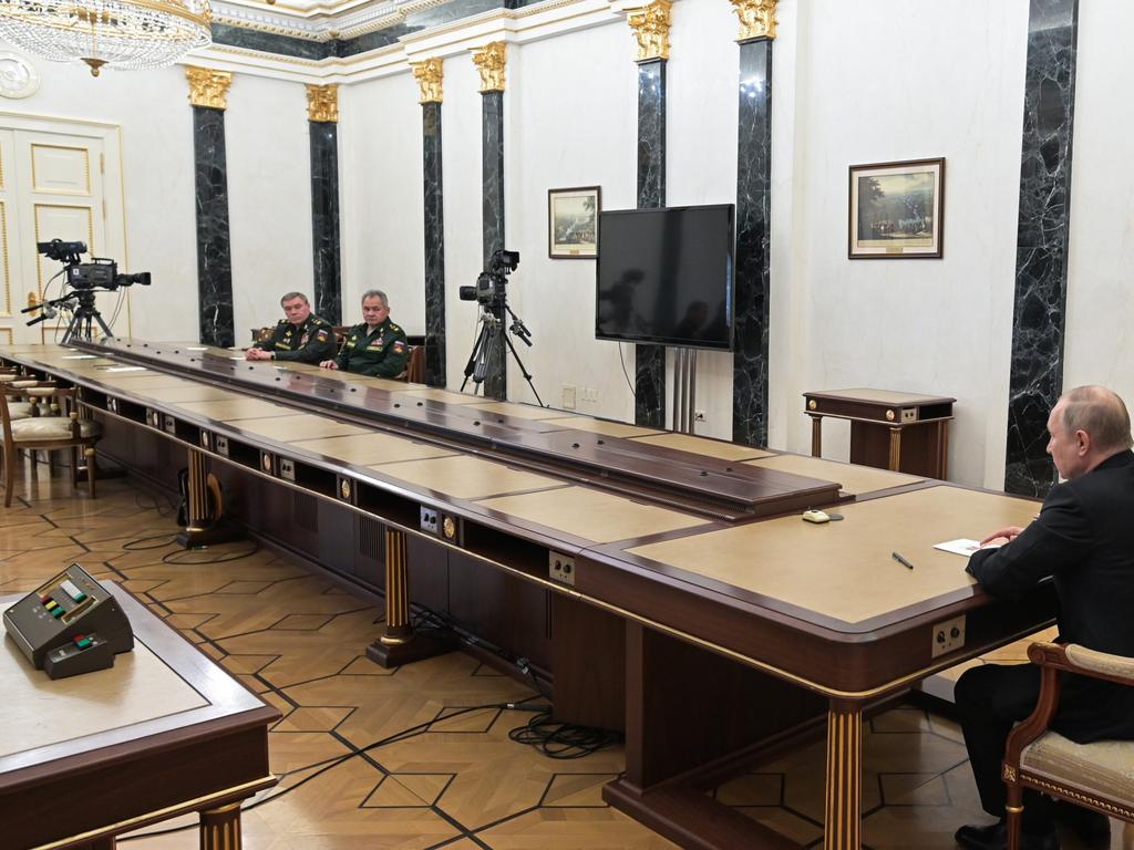 Russia's President Vladimir Putin meets with Russia's Defence Minister Sergei Shoigu and Valery Gerasimov [far left].