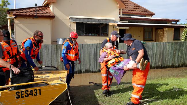 Dawn Saint is lifted out of the SES punt after being rescued from her house in Brushgrove near Maclean. Picture: Toby Zerna