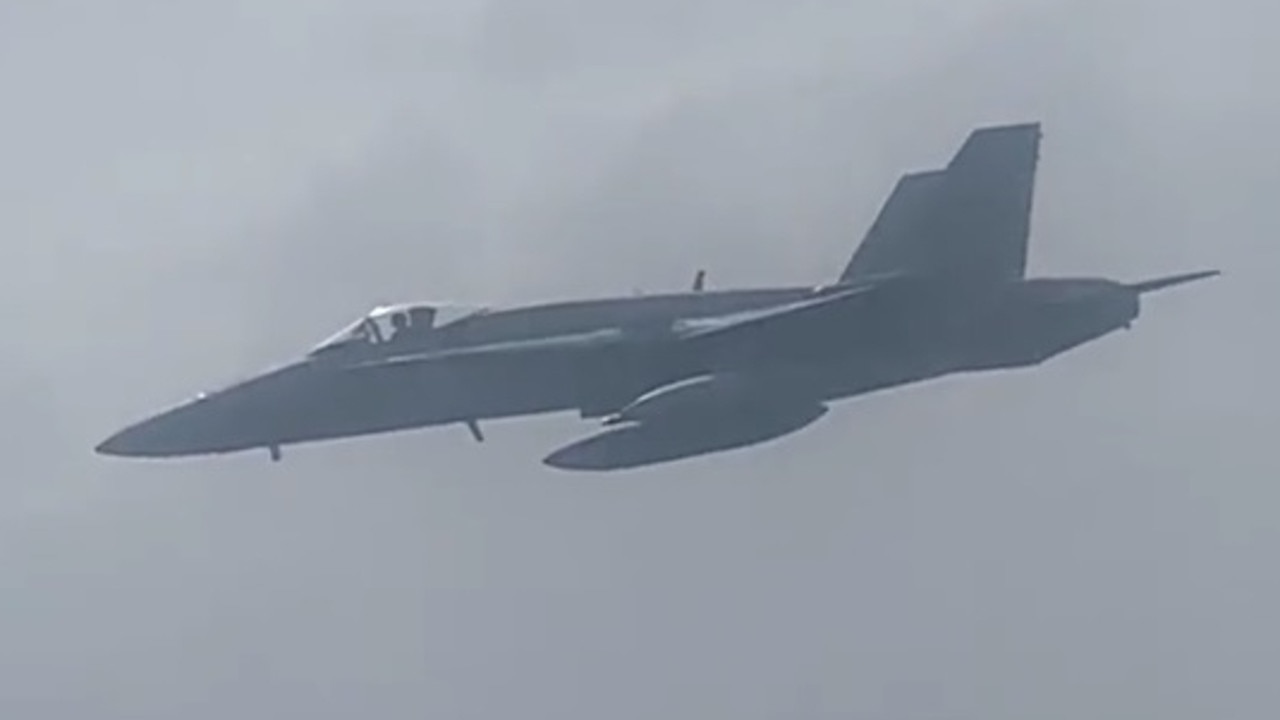 The pilot can be seen behind the controls of the Spanish fighter jet. Picture: Abigail Leslie/Robin Powell