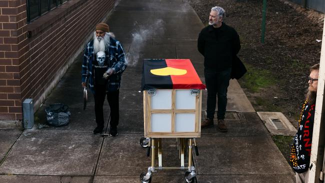 Uncle Major “Moogy” Sumner takes the Aboriginal remains, with SA Museum head of humanities, Professor John Carty.