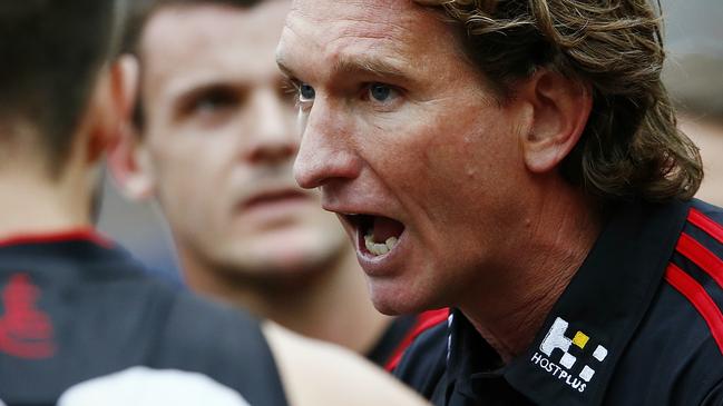 James Hird giving Essendon stars a pep talk at three-quarter time against the Hawks.