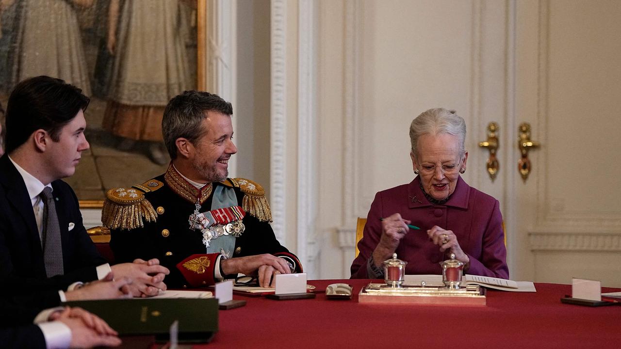 Queen Margrethe II of Denmark signs a declaration of abdication as Frederik becomes King and Christian becomes Crown Prince. Picture: AFP