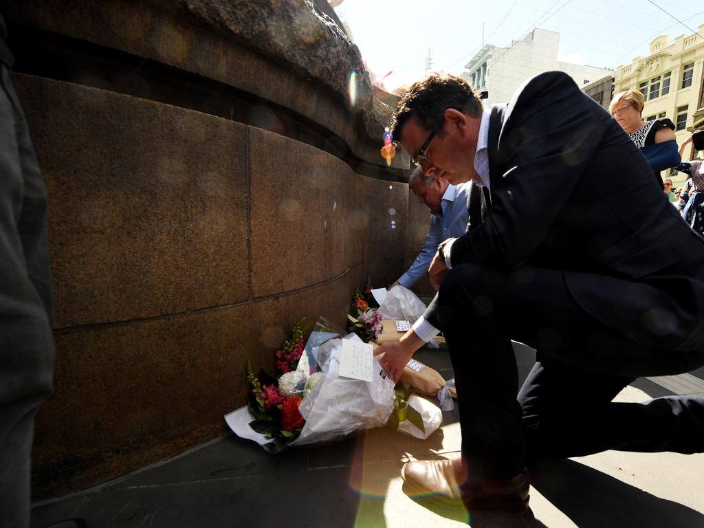 Daniel Andrews lays flowers at the corner of Bourke and Elizabeth streets after the car rampage in 2017. Picture: AAP