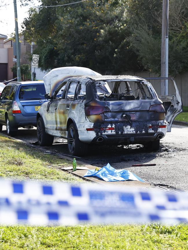 A burnt out car was found near the Revesby shooting. Picture: Richard Dobson