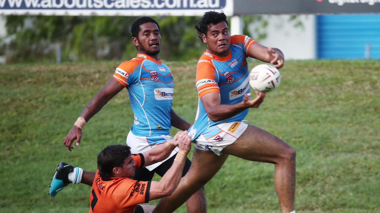 Pride's Jacob McCarthy manages to offload the ball in the ball in the Round 2 match of the Lightning Challenge between the Northern Pride Reef Kings and the Tully Tigers, held at Stan Williams Park. PICTURE: BRENDAN RADKE