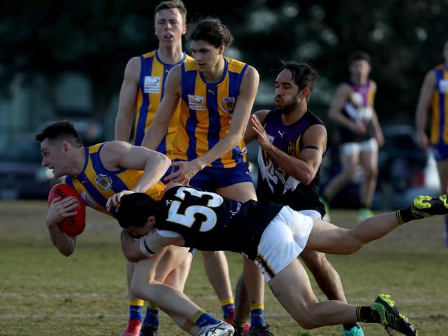 Noble’s Luke Bull is tackled by Kieren West of Norwood.