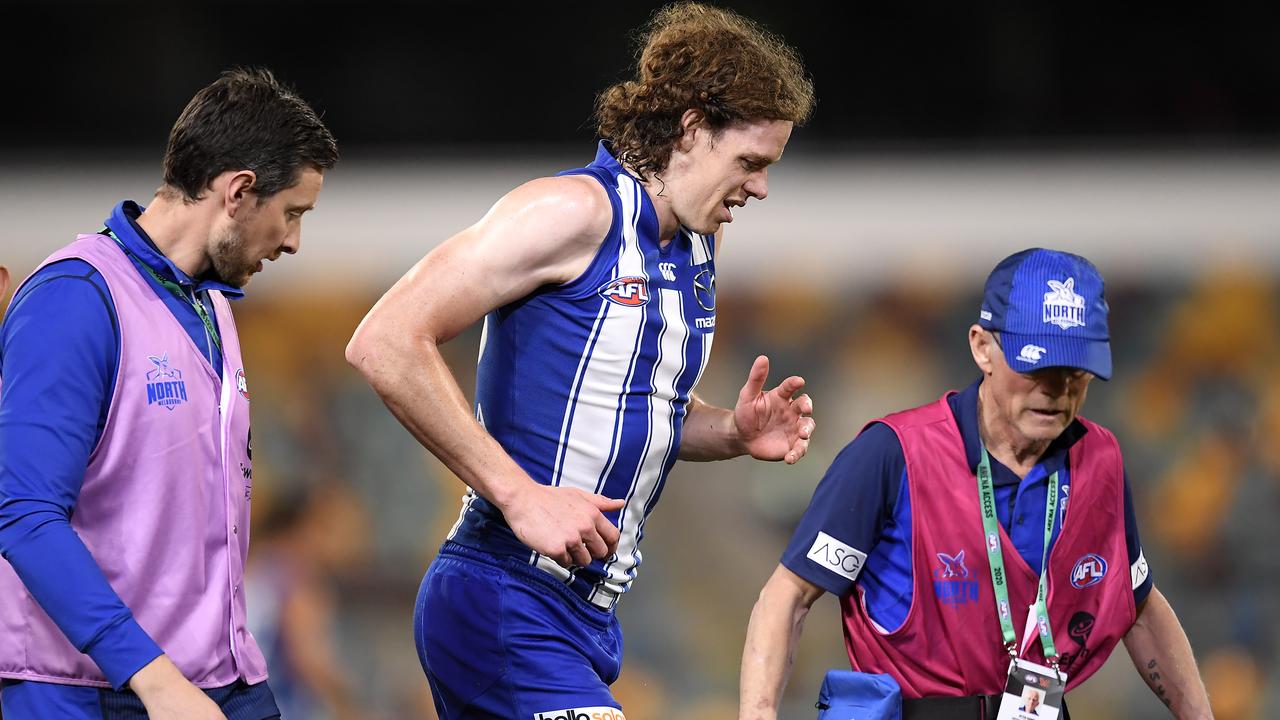 Ben Brown limps off the field after injuring his knee against Geelong. Picture: Albert Perez/AFL Media/via Getty Images