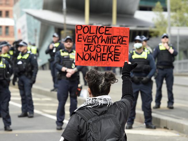 Protesters gather on Spencer Street Bridge to demonstrate against the Land Forces Expo at MECC. Picture: Andrew Henshaw