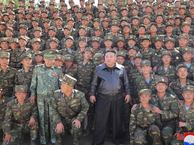 This picture taken on October 2, 2024 and released from North Korea's official Korean Central News Agency (KCNA) via KNS on October 4, 2024 shows North Korea's leader Kim Jong Un (C) posing with troops during an inspection at a training base of the Korean People's Army's special operations forces in the western region, at an undisclosed location in North Korea. North Korea's leader Kim Jong Un said his forces would use nuclear weapons "without hesitation" if Pyongyang's territory was attacked by the South and its ally the United States, state media reported on October 4. (Photo by KCNA VIA KNS / AFP) / South Korea OUT / REPUBLIC OF KOREA OUT ---EDITORS NOTE--- RESTRICTED TO EDITORIAL USE - MANDATORY CREDIT "AFP PHOTO/KCNA VIA KNS" - NO MARKETING NO ADVERTISING CAMPAIGNS - DISTRIBUTED AS A SERVICE TO CLIENTS / THIS PICTURE WAS MADE AVAILABLE BY A THIRD PARTY. AFP CAN NOT INDEPENDENTLY VERIFY THE AUTHENTICITY, LOCATION, DATE AND CONTENT OF THIS IMAGE --- /