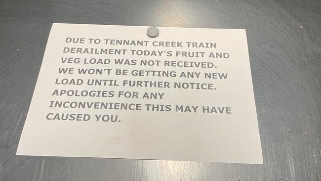 A message to shoppers at the Woolworths Alice Springs store advising shoppers of the shortages as a result of flooding. Picture: Laura Hooper