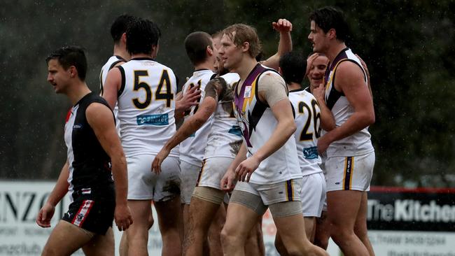 Tom Boyd celebrates with teammates after kicking a goal on his return to Norwood.