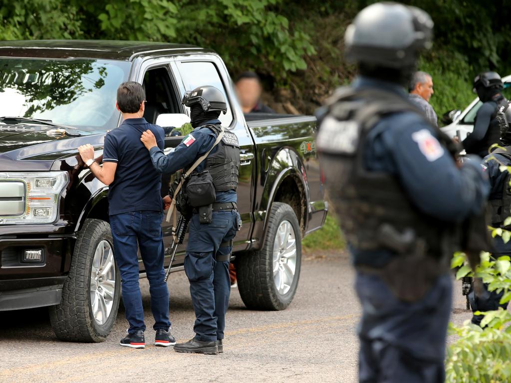 The Sinaloa State Police check suspicious vehicles on the quiet roads in a rural area outside of Culiacan in the search for Sinaloa Cartel members. Picture: Nathan Edwards