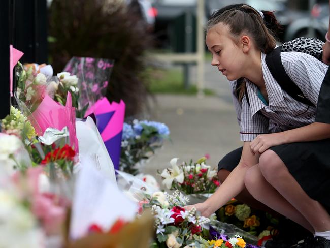 A Marsden State High School student lays flowers for Tiahleigh, after her body was found. Picture: Jack Tran