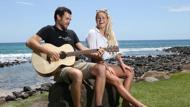 Aaron Fenech, surfer musician, and guitar maker of Fenech Guitars, with last year's womens winner of Burleigh Single Fin classic,  Felicity Palmateer at Burleigh Point.The music and surf scenes now go hand in hand on the Gold Coast.Picture Glenn Hampson