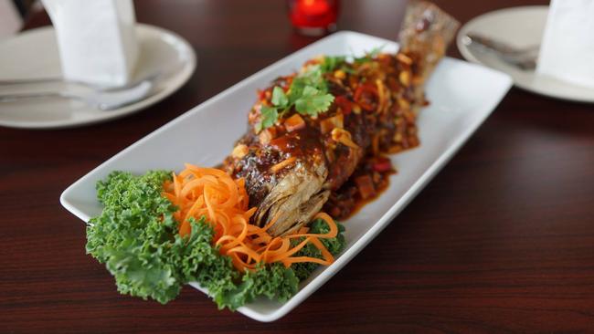 Colourfully garnished whole fish dish at Xthailence.