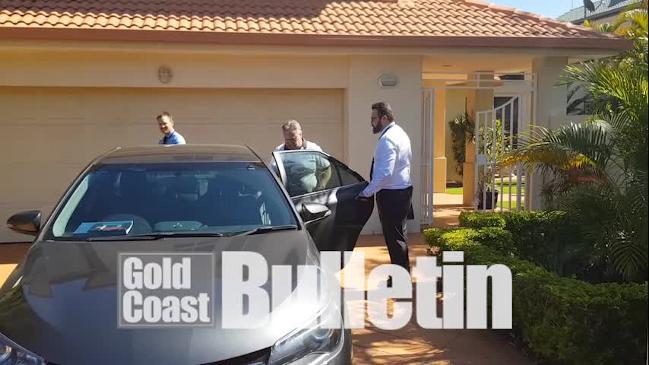 Andrew Eustice is led away from his home in Surfers Paradise by detectives.