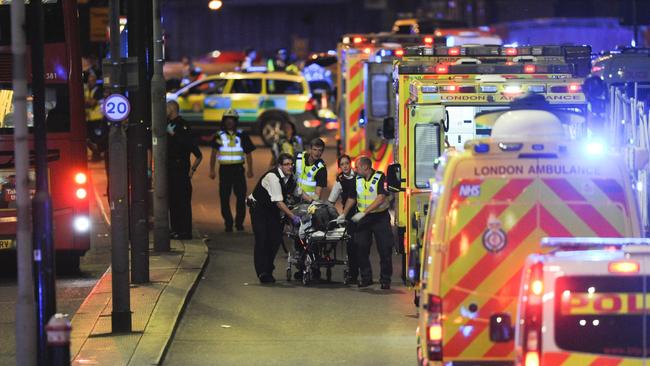 Police and ambulance personnel attend to the injured following the June 3, 2017, attack. Picture: AFP