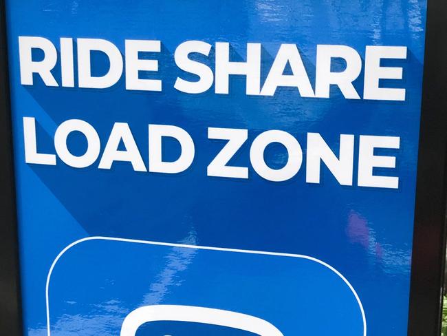 A ride share loading zone sign.