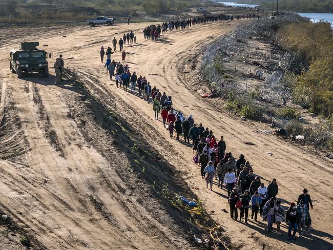 More than 1,000 immigrants walks towards a US Border Patrol field processing centre after they crossed the Rio Grande from Mexico in December 2023 in Eagle Pass, Texas. Picture: John Moore/Getty Images