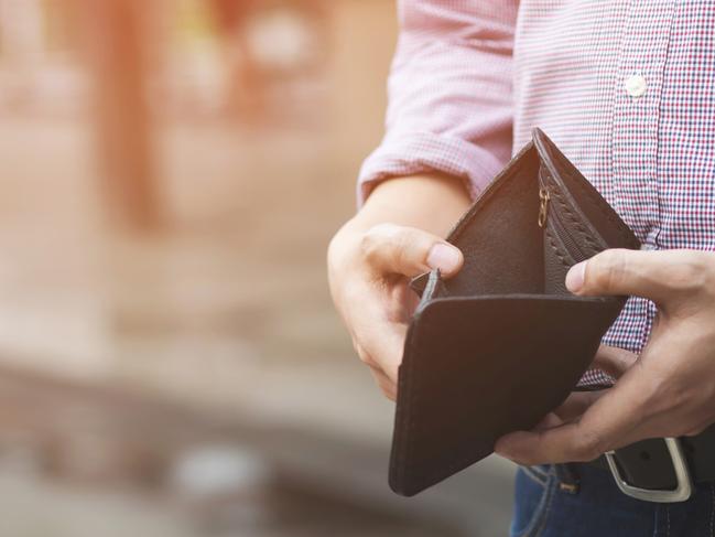 Empty wallet (no money) in the hands of an businessman. High cost of living in city Cost control expenses poverty in concept.