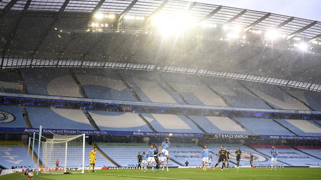 Players in front of the empty stands during the Premier League match between Manchester City and Arsenal at the Etihad Stadium, in Manchester. Picture: AP