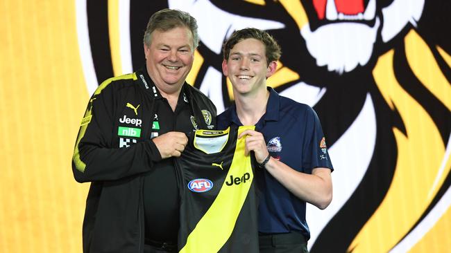 Riley Collier-Dawkins receives his Richmond jumper from Neil Balme. Picture: AAP