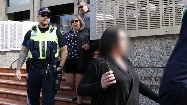 Melissa Oates leaves Hobart Magistrates Court under police escort after her court hearing following Huonville road death of boyfriend Jari Wise was adjourned. Picture: Zak Simmonds